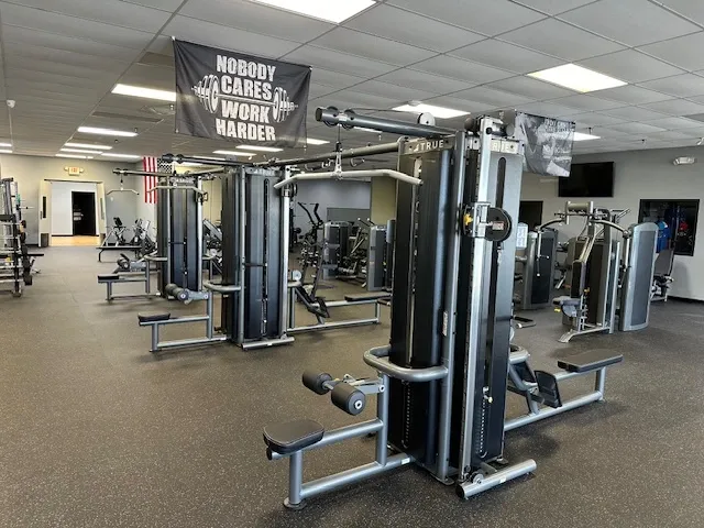 A gym with many different machines in it
