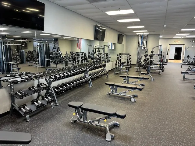 A gym with many different types of exercise equipment.