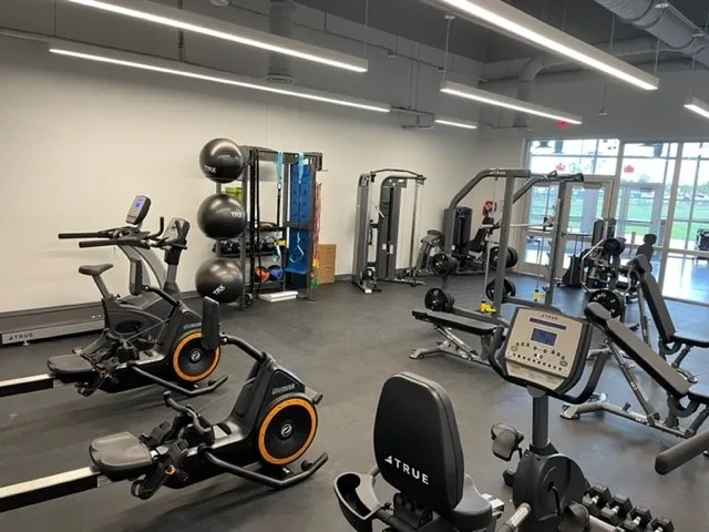 A gym with many different machines and equipment.