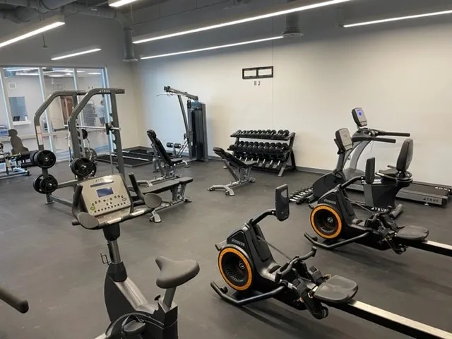 A gym with many different machines and equipment.