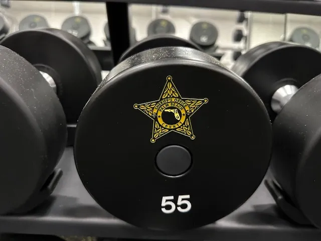 A close up of some weights with a sheriff star on them