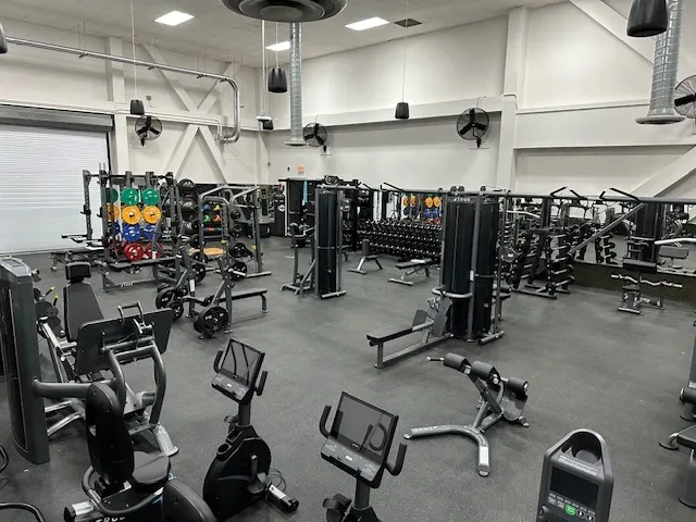 A gym with many different machines in it