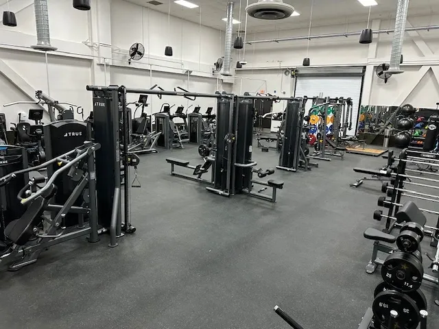 A gym with many different machines in it