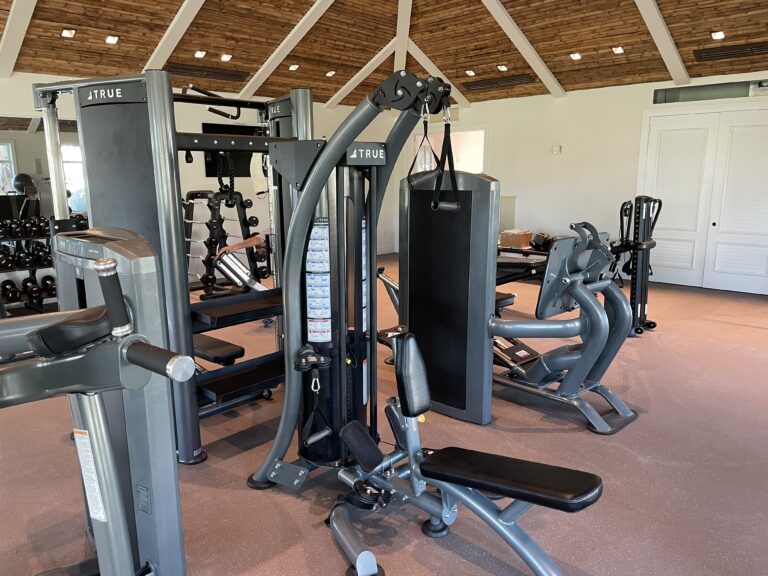 Modern gym with various exercise equipment.