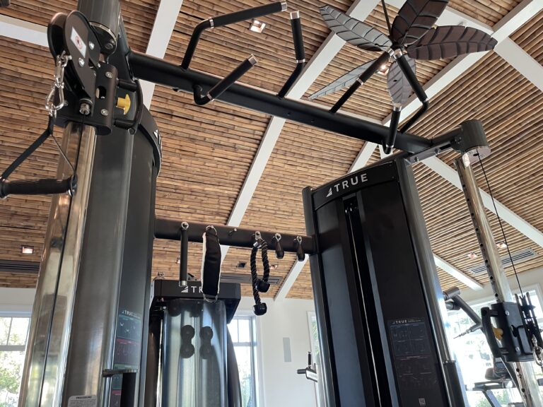 Gym equipment under wooden ceiling fan.