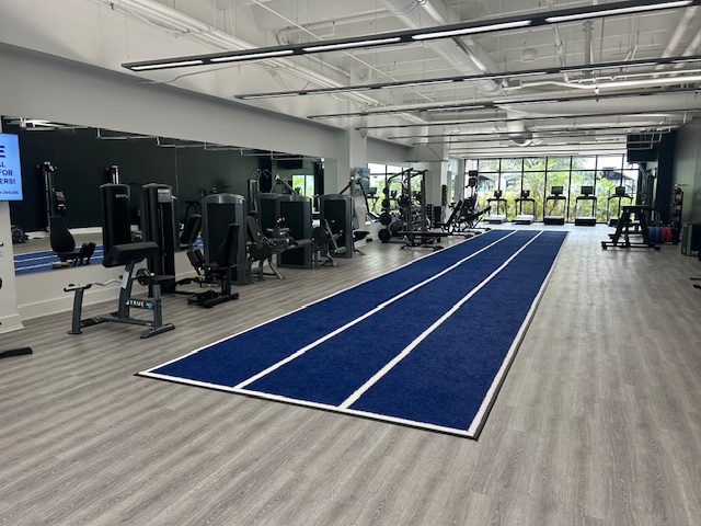 Modern gym with blue indoor track.