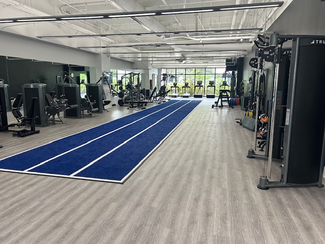 Modern gym with blue indoor track.